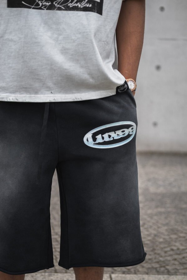 Close-up of the LUX99TM logo print on the Baggy Jorts